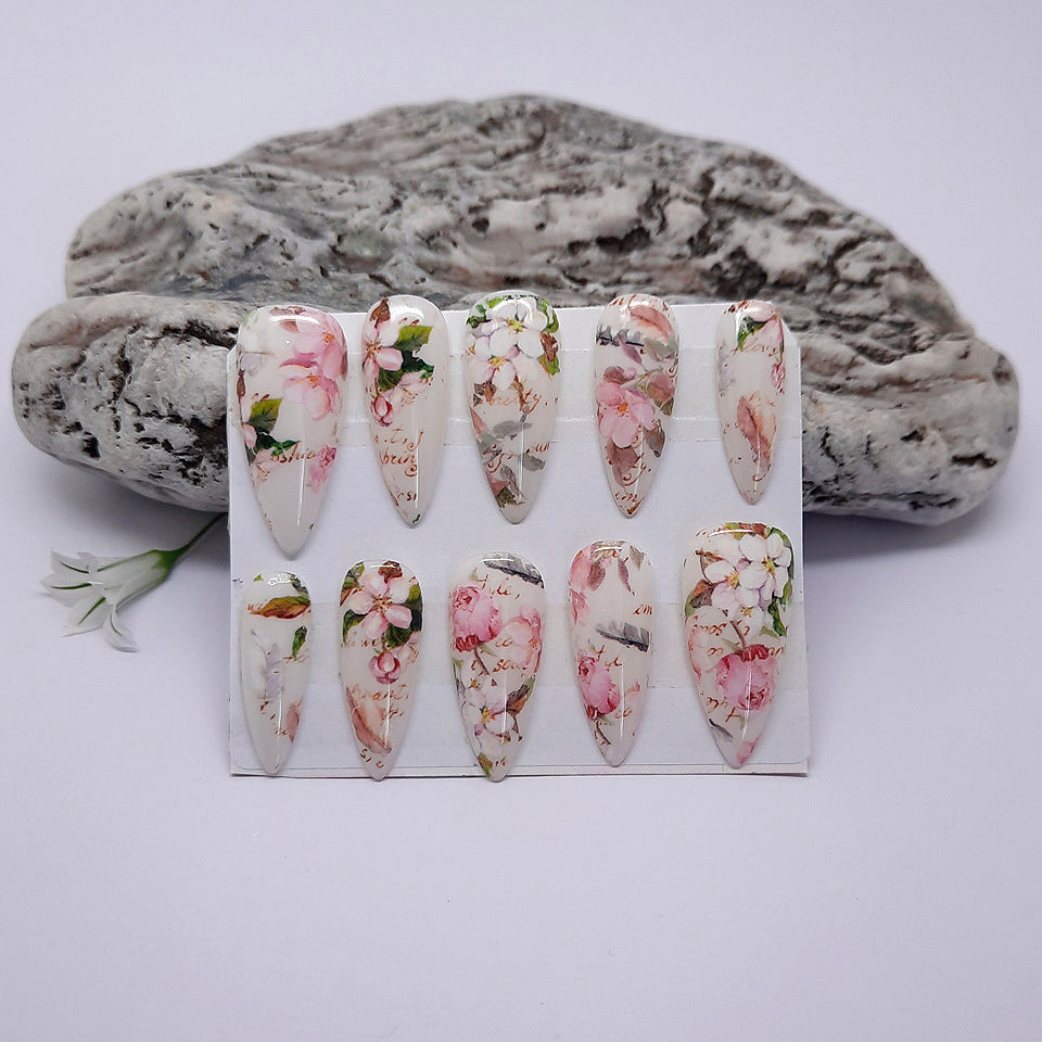 A set of decorative press on nails on a white background.