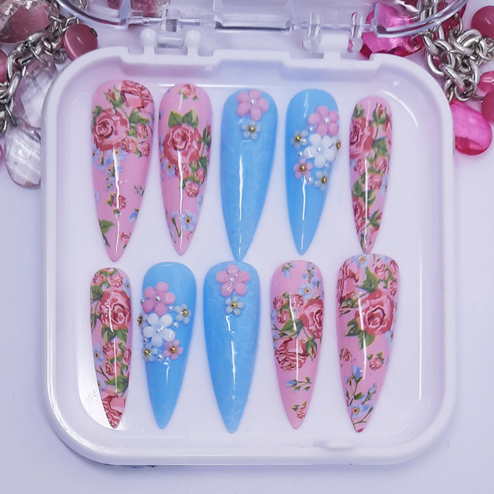 Set of floral and blue nail art designs in a white case.