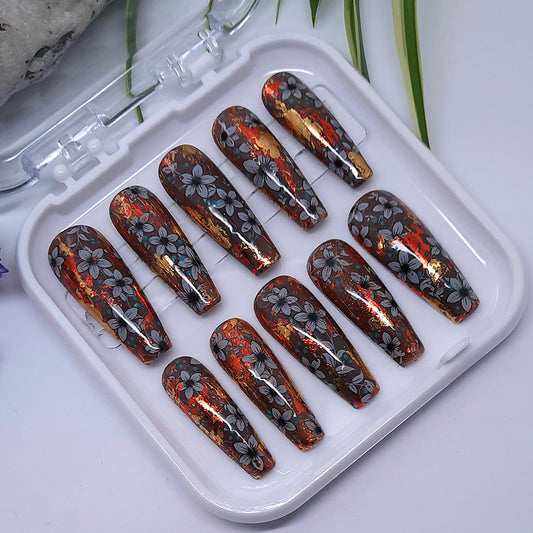 Gorgeous abstract press on nails in browns, orange and red with flowers. Finished with a glossy top coat.