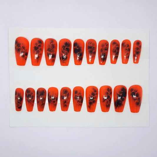 a stunning one size fits all press on nails set, in bright orange with a black smokey design on each nail
