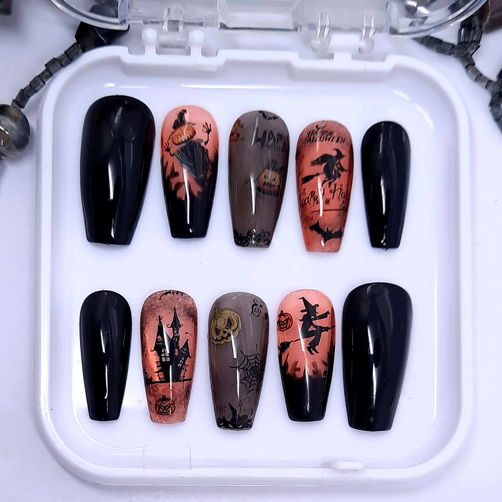 A set of halloween themed press on nails with designs including witches and pumpkins.
