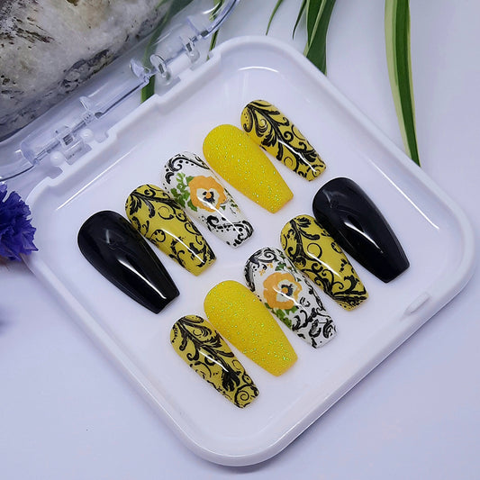 Stunning press on nails. Black, yellow and white, glitter, flowers and swirly decoration.