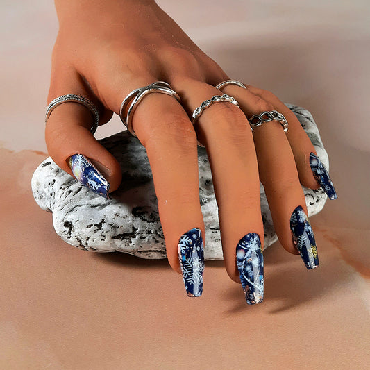 blue Christmas press on nails with an abstract snowflake design