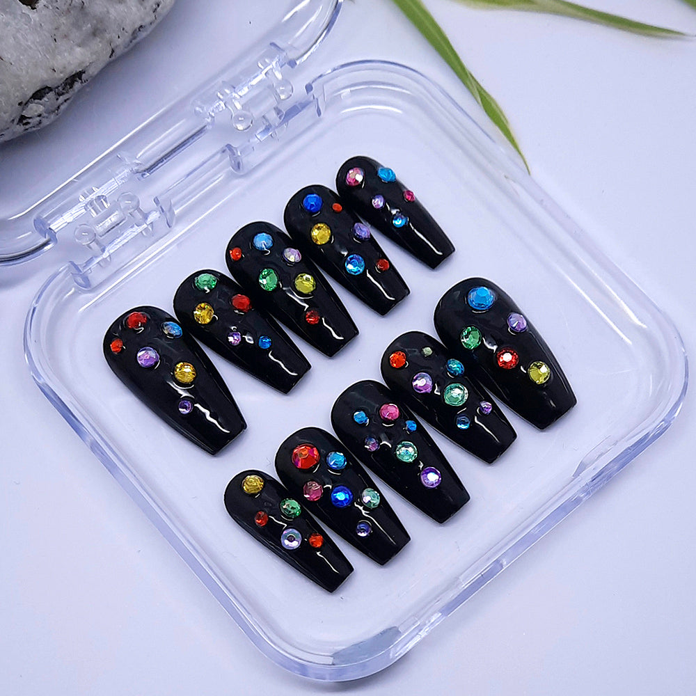This is a fun set of press on nails. Glossy black, with coloured gems.