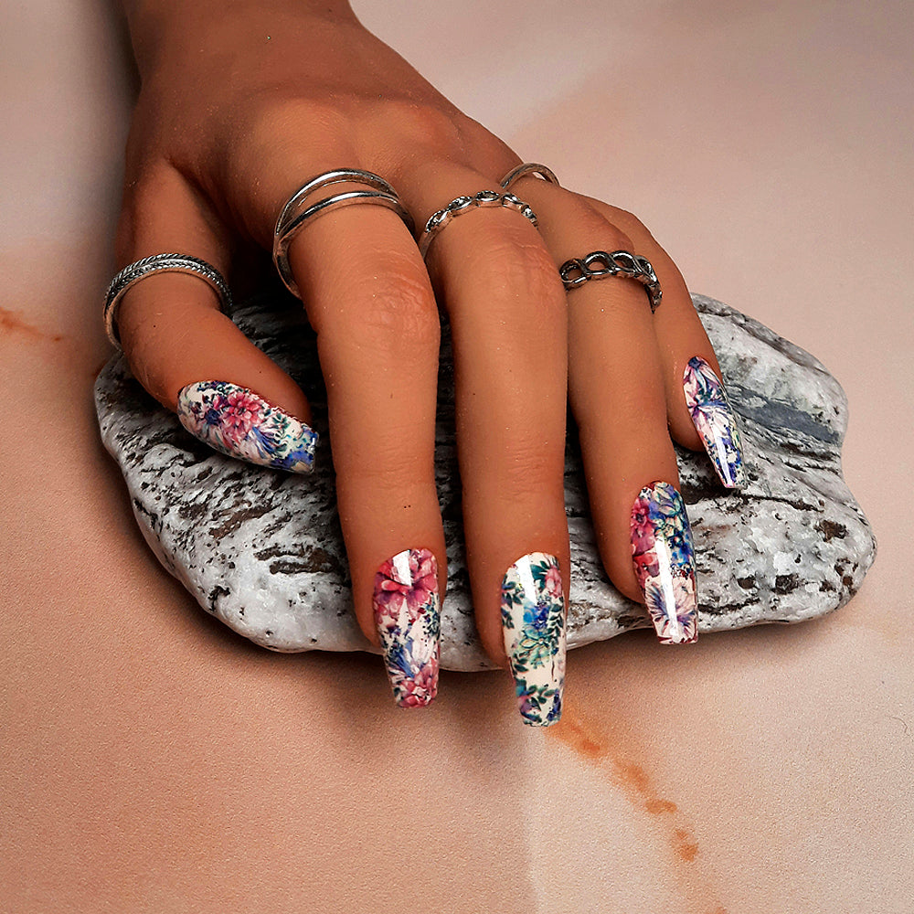 A beautiful set of hand made coffin press on nails in a soft cream gel polish, and covered in flowers and leaves.