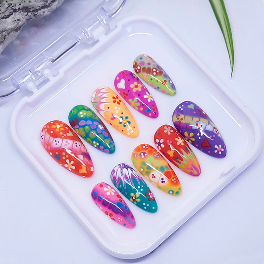 Colorful nail art designs on a white tray with a light background