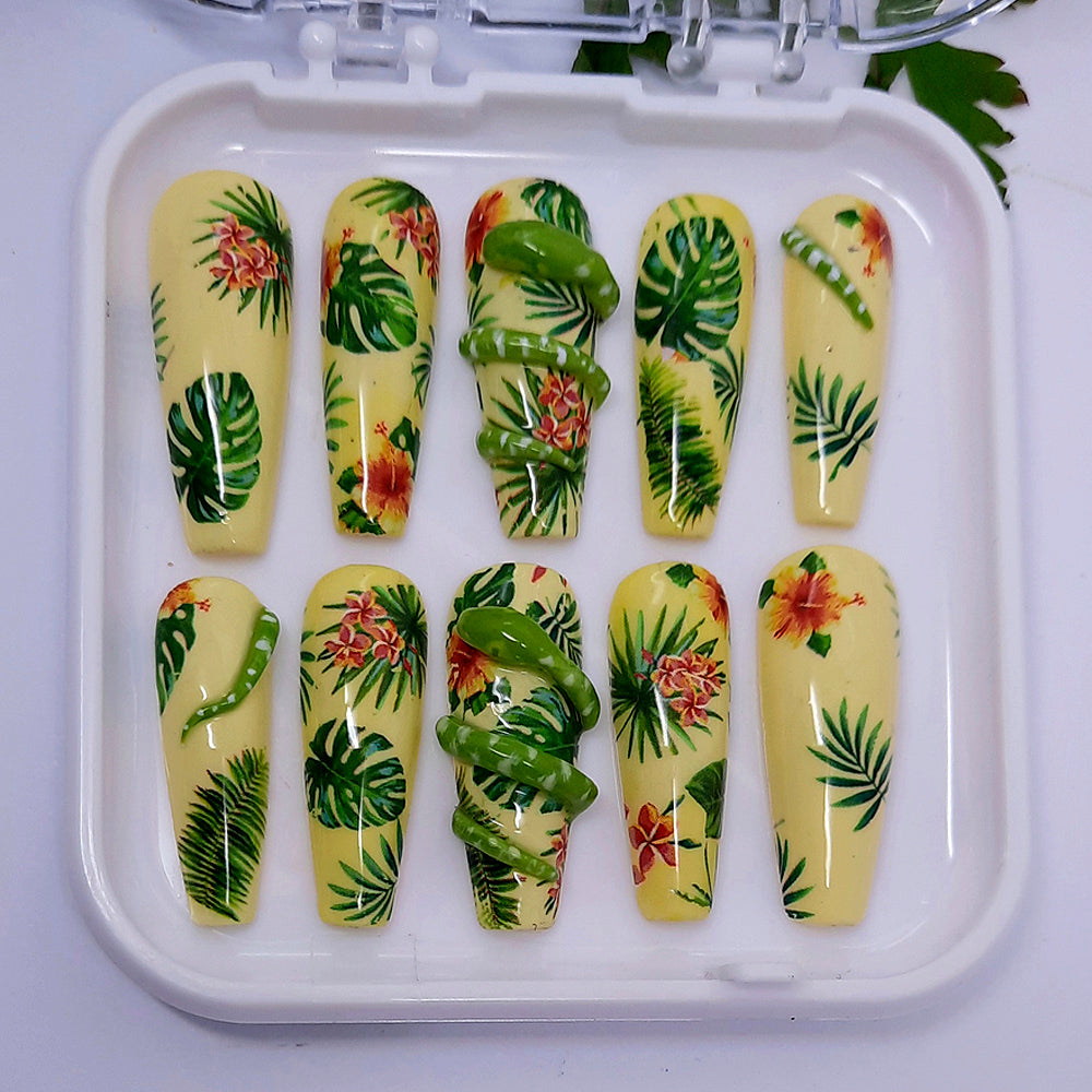hand made yellow long coffin press on nails, in a jungle theme with exotic leaves and flowers, and hand made 3d snakes