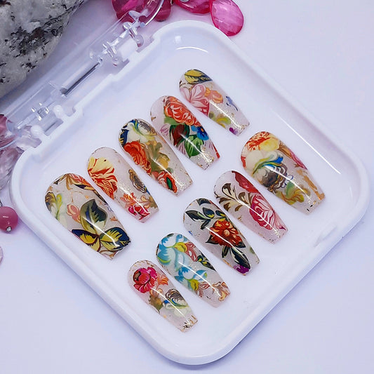Set of colourful floral press on nails on a white tray with a white background.