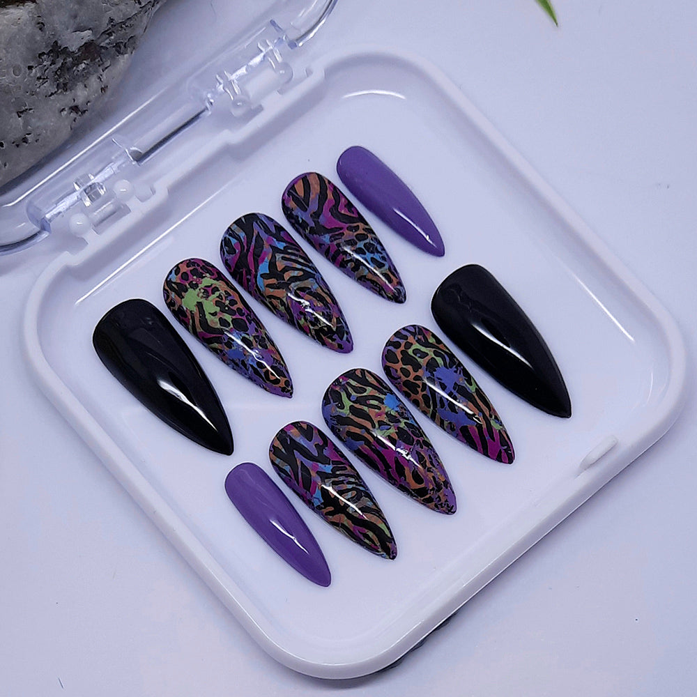 A beautiful set of press on nails. Black and lilac with an abstract animal print design, finished with a glossy top coat.