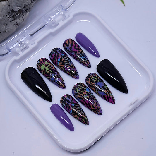 A beautiful set of press on nails. Black and lilac with an abstract animal print design, finished with a glossy top coat.