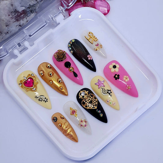 pink , black, yellow and gold press on nails with 3d nail art