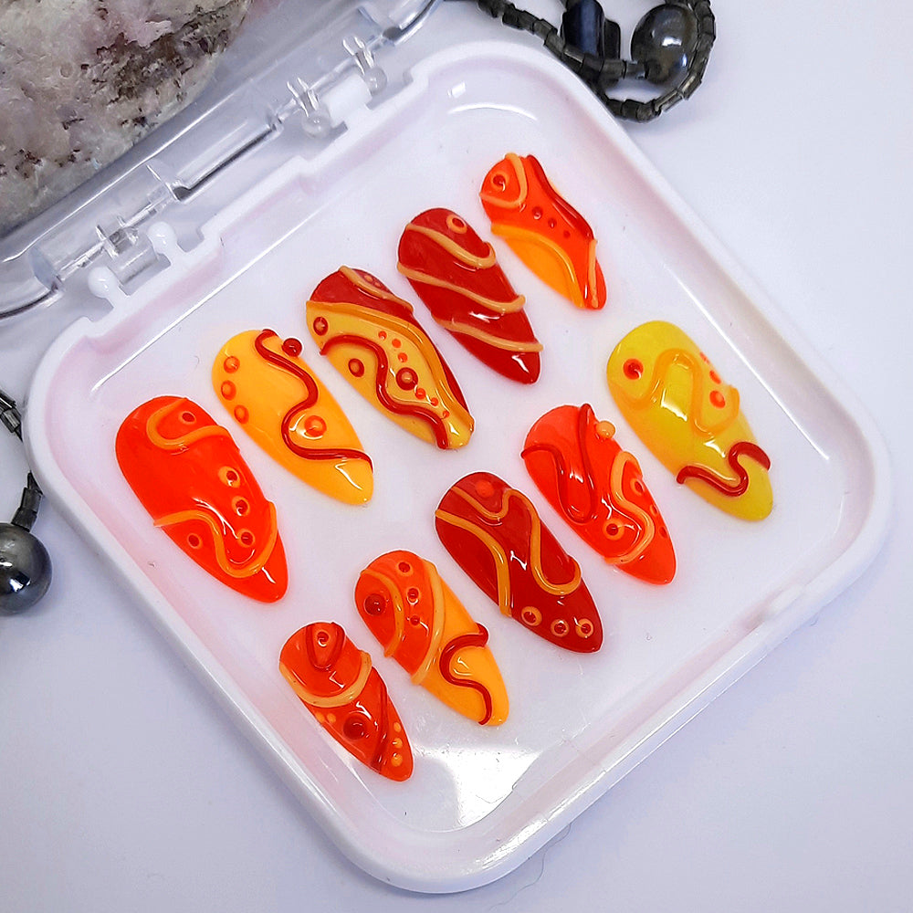 Bright and crazy press on nails in red, orange and yellow with 3D swirls and dots