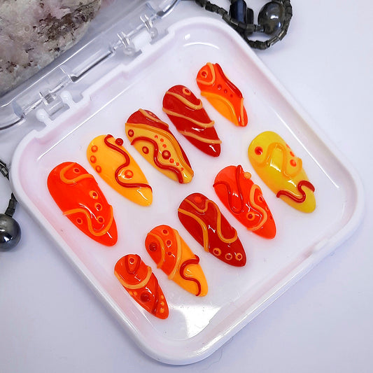 Bright and crazy press on nails in red, orange and yellow with 3D swirls and dots