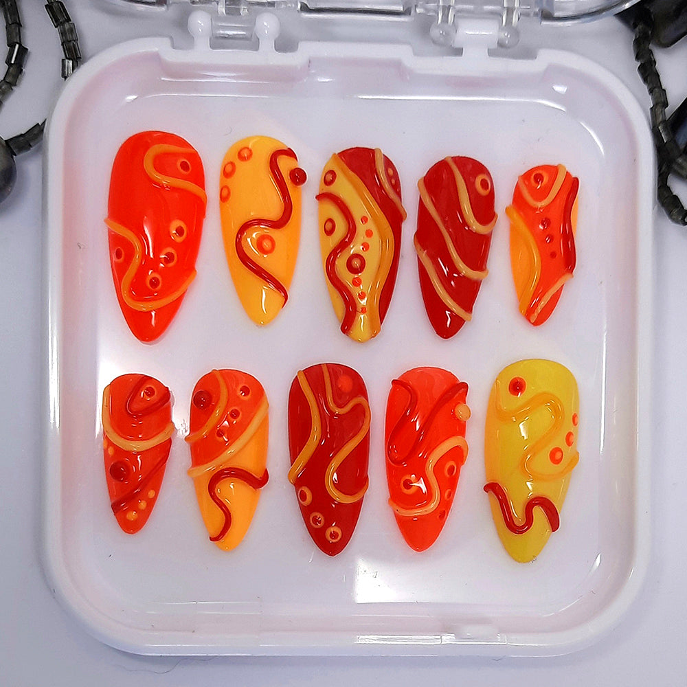 Bright and crazy press on nails in red, orange and yellow with 3D swirls and dots