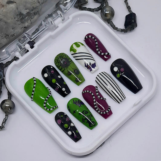 A set Beetlejuice inspired press on nails