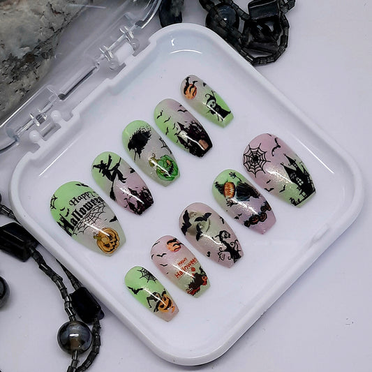 A set of spooky halloween press on nails with various designs including witches, bats, spider webs and pumpkins.