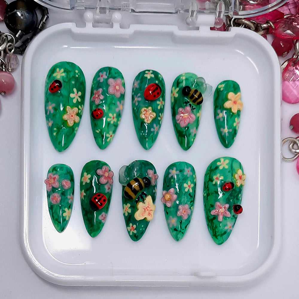 Really cute press on nails with hand made 3d flowers, bees and ladybirds. Finished in gloss top coat.