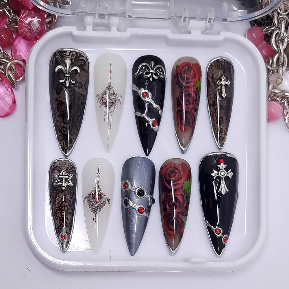 Beautiful press on nails in black, black jelly, milky white and a grey chrome nail; black lace, roses, silver chrome and 3d nail art. Finished in gloss top coat.