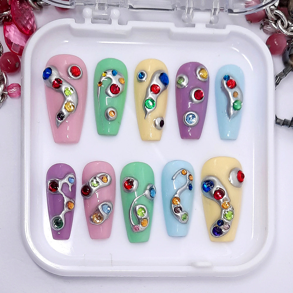 Beautiful press on nails in pretty pastel shades, with 3d silver chrome and coloured gems. Finished in gloss top coat. These are so cool.
Please select your size, shape & length. Medium Coffin is pictured.
Unsure of your size? Please read our info on sizing, you can also purchase one of our sizing kits to be absolutely sure of a perfect fit.
Every order of Moona press on nails comes with a free application kit.