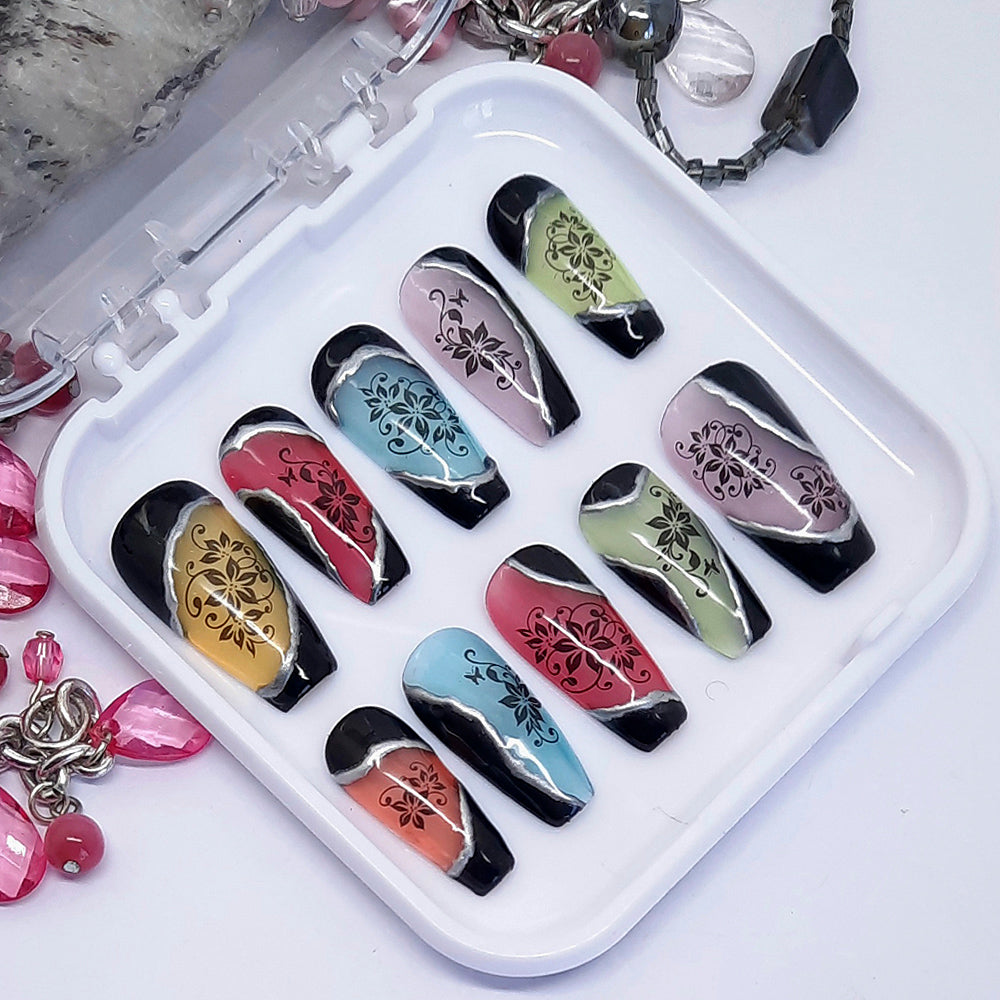Beautiful press on nails in sheer jelly colours plus solid black, with 3d silver chrome and black flowers. Finished in gloss top coat. These are so cool.