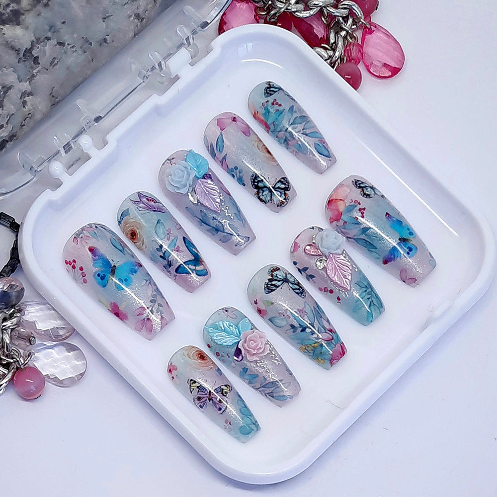 Beautiful press on nails in semi sheer shimmering blue and lilac, with flowers, butterflies and some beautiful 3d nail art. Finished in gloss top coat. These are so pretty.