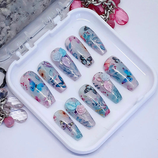 Beautiful press on nails in semi sheer shimmering blue and lilac, with flowers, butterflies and some beautiful 3d nail art. Finished in gloss top coat. These are so pretty.