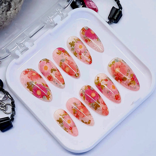 Beautiful press on nails in soft and subtle shimmering pink and orange, with beautiful roses in shades of pink. Finished in gloss top coat.