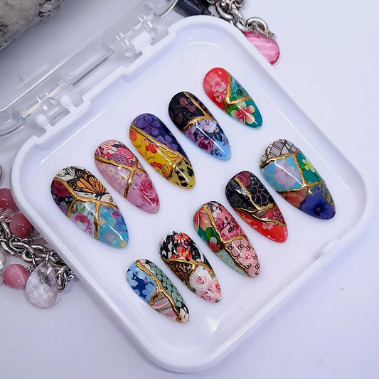 Very beautiful and unique press on nails in a floral patchwork design with gold chrome. Finished in gloss top coat.
