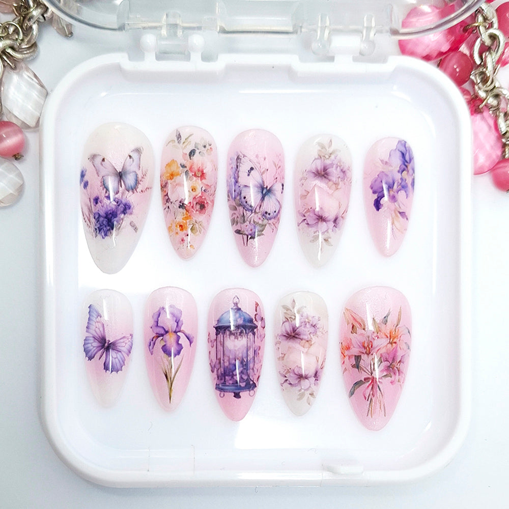 Set of nail art designs in a white case with floral and butterfly patterns.