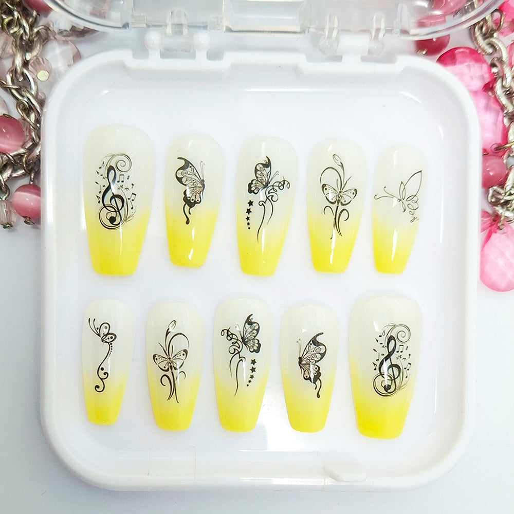 Yellow nail art designs with butterfly and music note patterns in a white case.