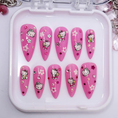 Pink nail art designs with Hello Kitty characters in a white case.