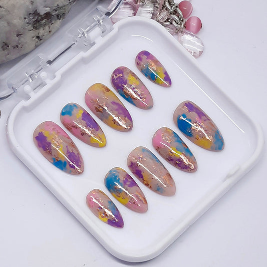 A popular set of press on nails, in an abstract design and a mix of gorgeous colours, with added nail foil, and finished with a glossy top coat.