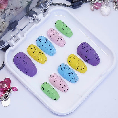 Mini Eggs Press On Nails, popular nails for Easter! Finished with a matte top coat.

Please select your size, shape &amp; length.&nbsp;Short Coffin is pictured.

Unsure of your size? Please read our info on sizing, you can also purchase one of our sizing kits to be absolutely sure of a perfect fit.

Every order of Moona press on nails comes with a free application kit.