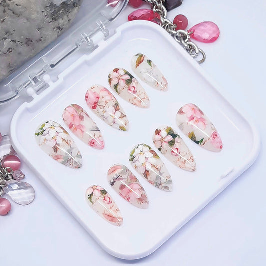 Decorative press on nails with floral designs on a white tray.