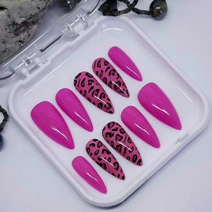 Beautiful pink press on nails with an animal print foil. Finished with a glossy top coat.

Please select your size, shape and length. Medium Stiletto is pictured.