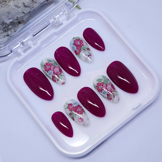 Burgundy and white press on nails with pretty flowers, finished with a glossy top coat.

Please select your size, shape & length. Short Almond is pictured.