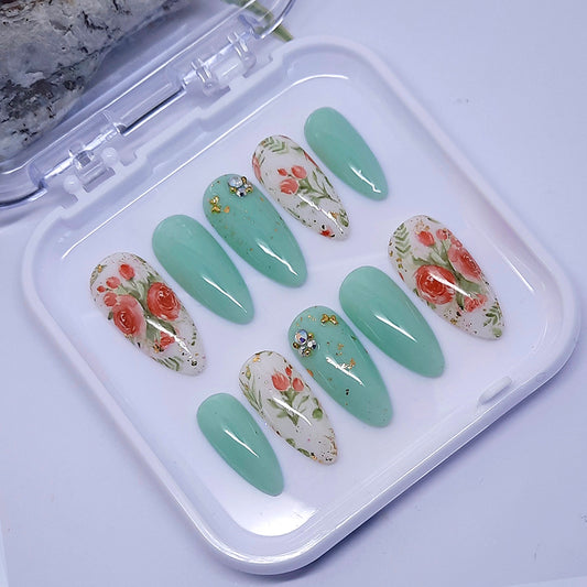 Beautiful green and milky white press ons with roses and gold decoration, finished with a glossy top coat.