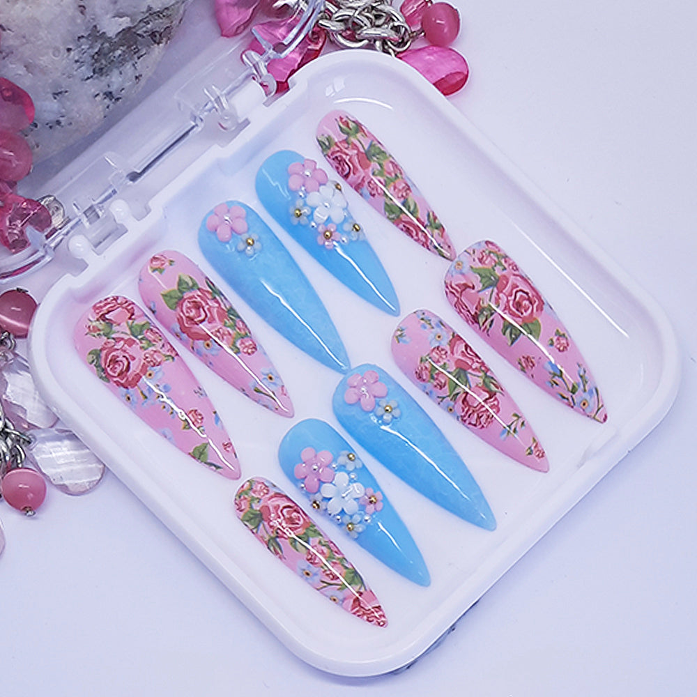 Set of floral nail art designs on a white tray with decorative elements.