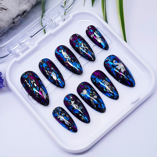 Set of blue and purple nail art designs in a white case on a light background