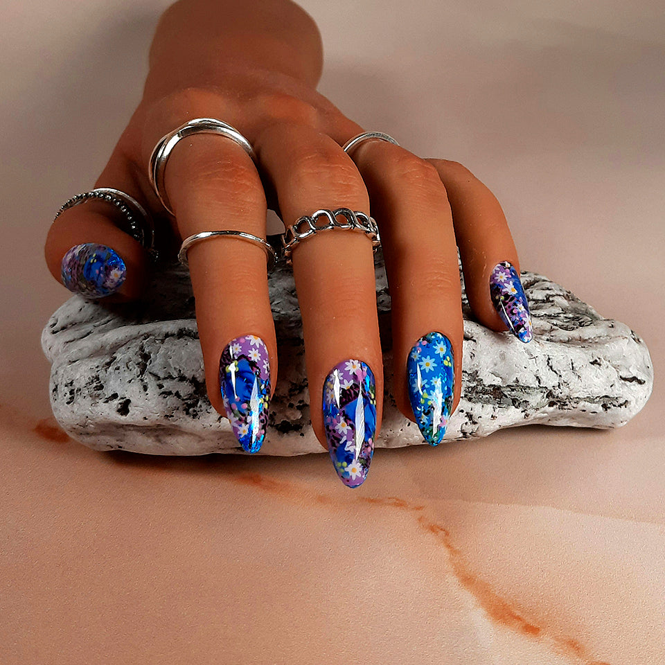 hand made reusable press on nails in a theme of blue and lilac, with an abstract flower design