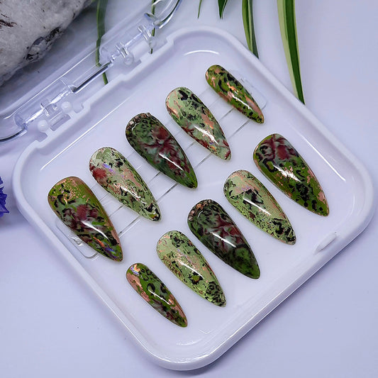 A stunning set of abstract press on nails in green with abstract leopard print and flower design, with rose gold foil and rose gold studs accent. Finished with a glossy top coat.