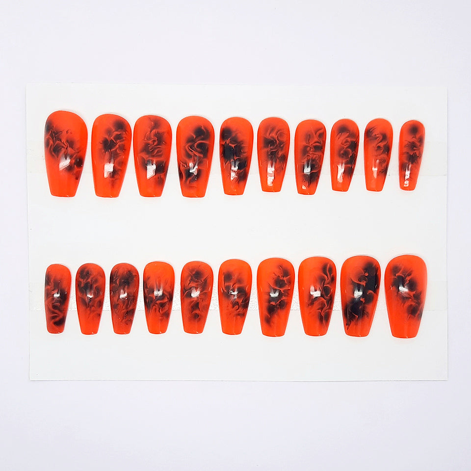 Set of orange and black nail art designs on a white background