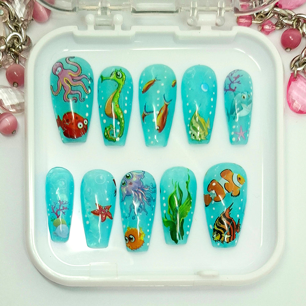 Set of nail art designs with underwater theme on a tray