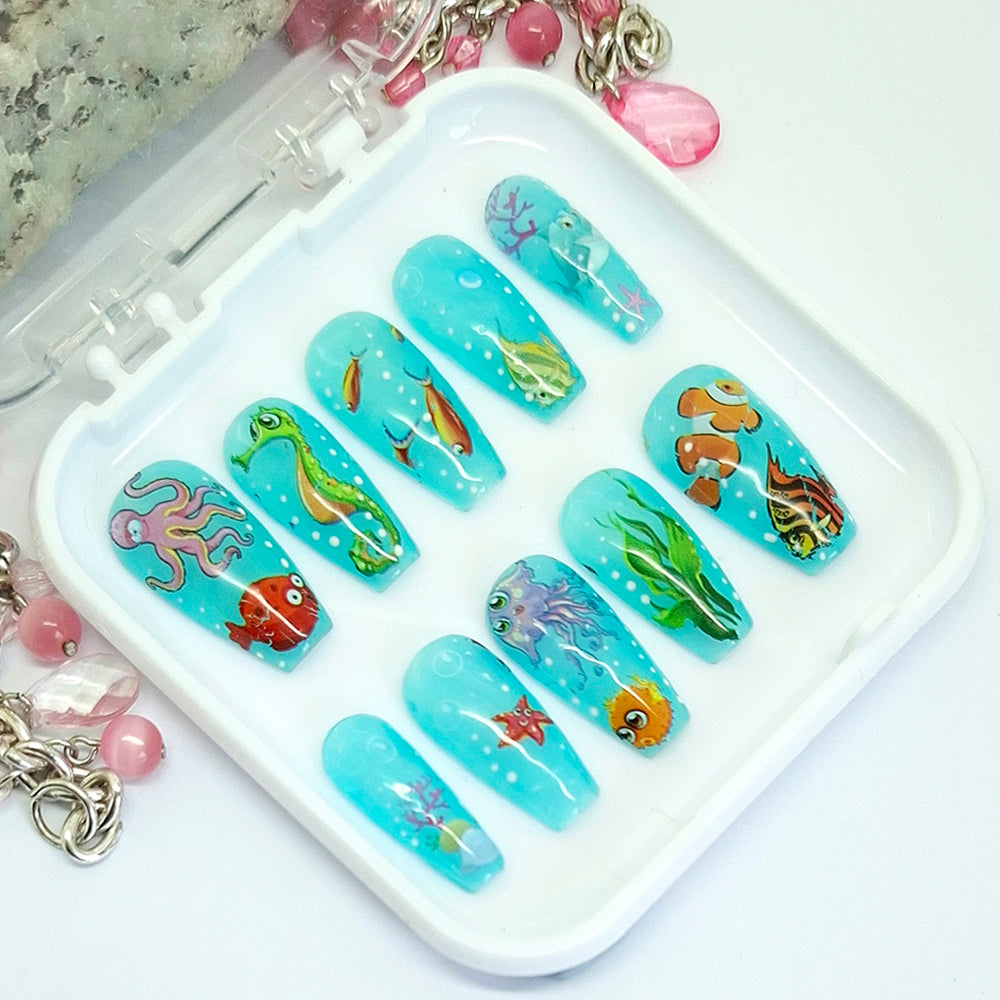 Nail art designs with underwater theme on a white tray