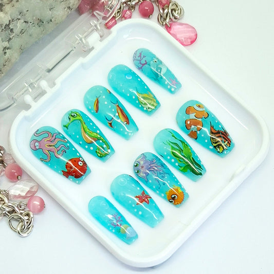 Nail art designs with underwater theme on a white tray