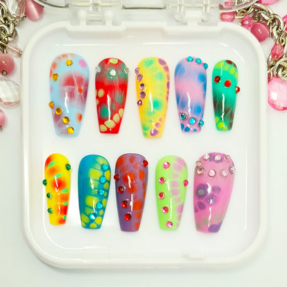 Set of colorful nail art designs on a white tray with decorative elements.