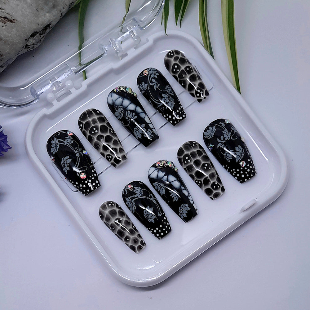 Beautiful hand made coffin press on nails in black and white, and a stunning design with flowers and crystals