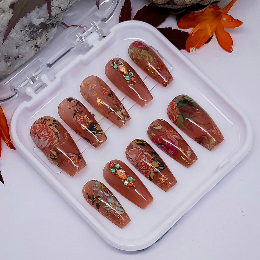 Brown jelly nails with flowers, leaves, crystals and gold flakes