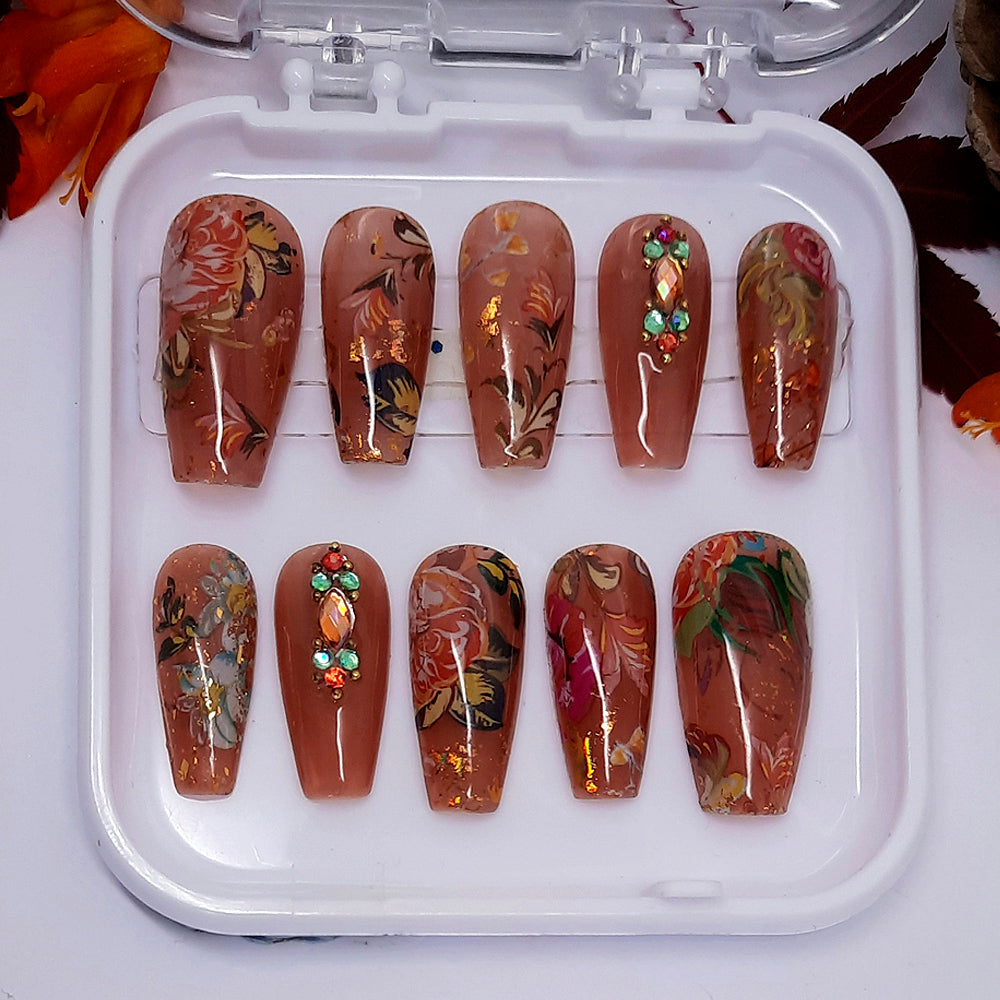 Brown jelly nails with flowers, leaves, crystals and gold flakes
