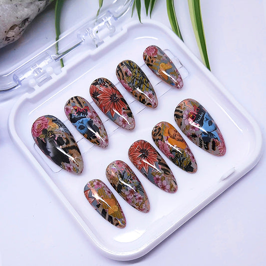 A set of press on nails with an abstract pop art design in multicolours in a white tray.